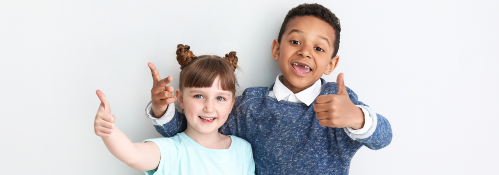 Two children giving a thumbs up in recognition of CARF accreditation